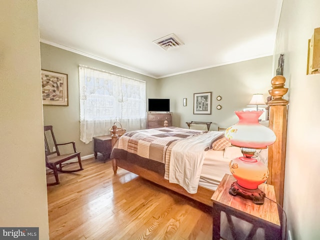 bedroom featuring ornamental molding and wood-type flooring