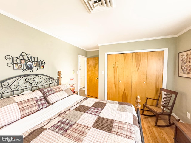 bedroom featuring a closet, hardwood / wood-style flooring, and ornamental molding