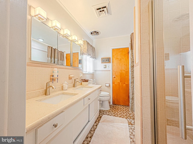 bathroom with curtained shower, tile patterned floors, vanity, tile walls, and toilet