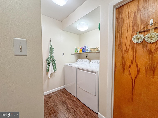 laundry area featuring hardwood / wood-style flooring and washer and clothes dryer