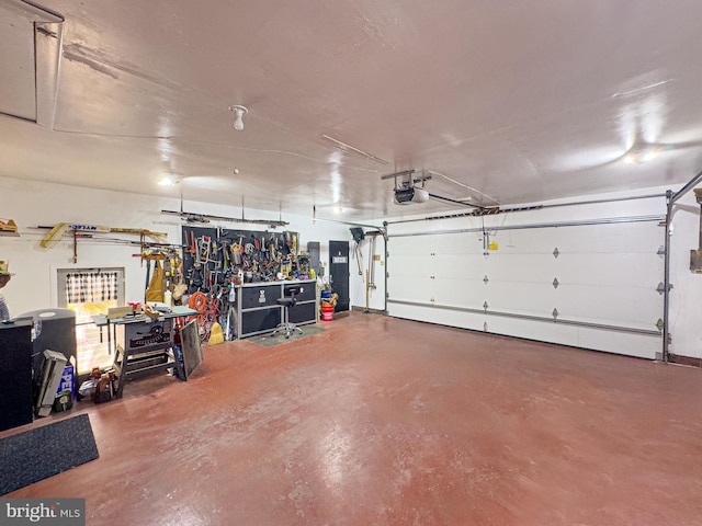 garage featuring a workshop area, baseboard heating, and a garage door opener