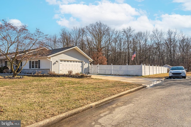 view of side of property featuring a garage and a yard