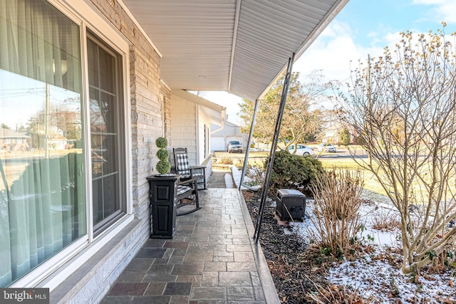 view of patio with a porch and central air condition unit