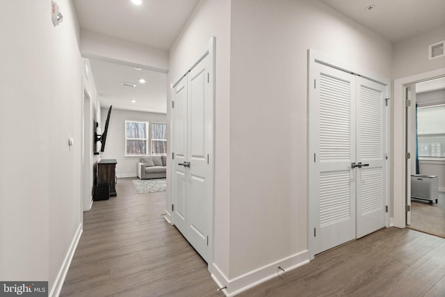 hallway with light hardwood / wood-style flooring