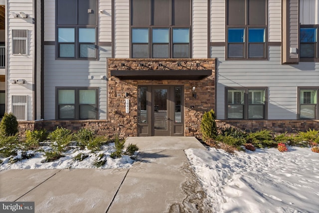 view of snow covered property entrance