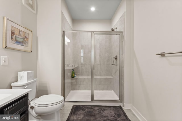 bathroom with vanity, toilet, an enclosed shower, and tile patterned flooring