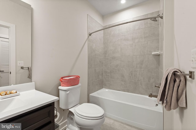 full bathroom featuring vanity, tiled shower / bath combo, and toilet