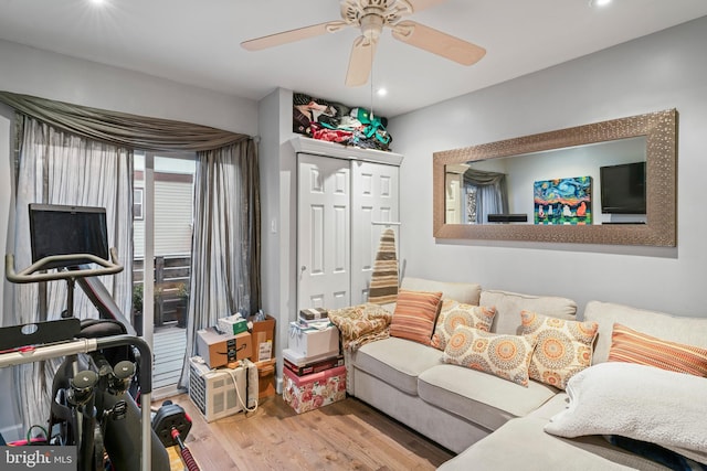 living room with ceiling fan and light hardwood / wood-style flooring