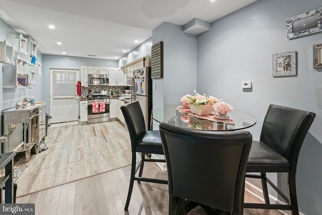 dining space with light hardwood / wood-style floors