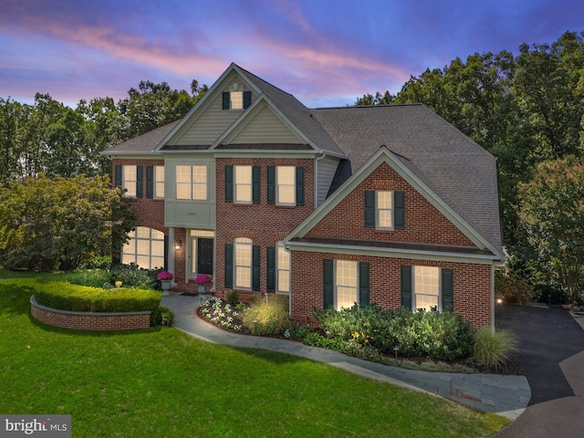 craftsman-style home featuring a lawn