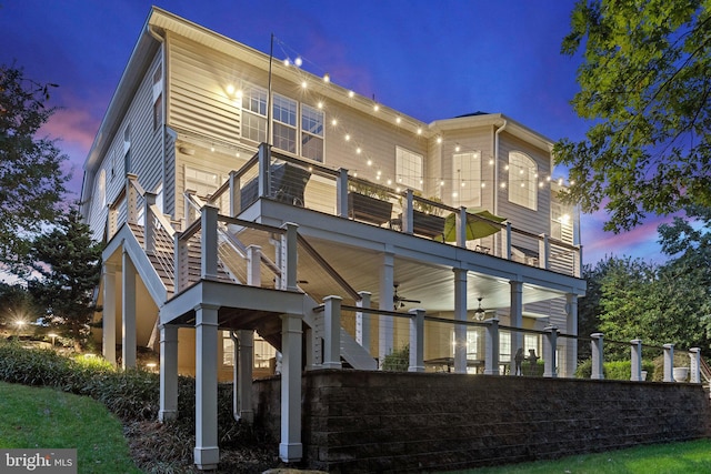 back house at dusk with a balcony