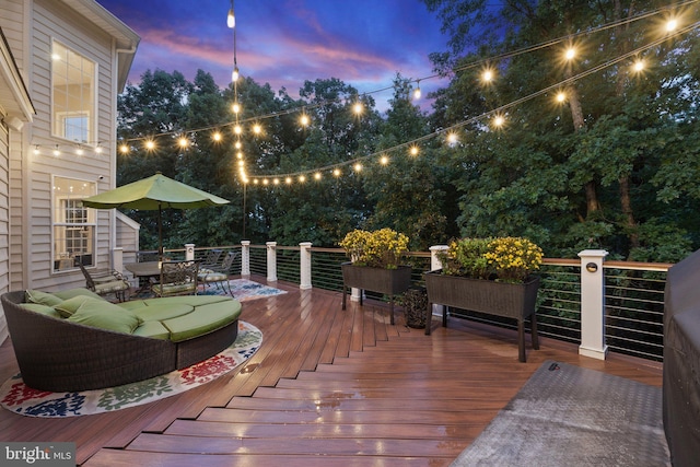 deck at dusk with an outdoor living space