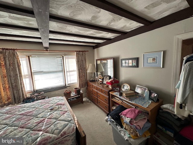 carpeted bedroom featuring beam ceiling