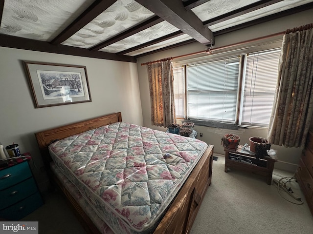 bedroom featuring carpet floors and beam ceiling