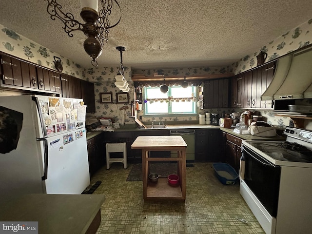 kitchen with decorative light fixtures, white appliances, dark brown cabinets, and custom range hood