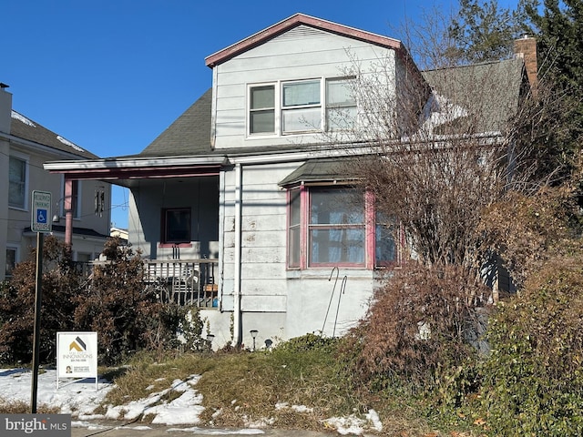 view of snow covered exterior featuring a porch