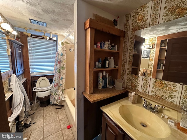 bathroom featuring vanity and shower / bathtub combination with curtain