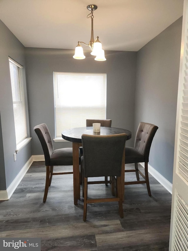 dining area featuring a chandelier and dark hardwood / wood-style flooring