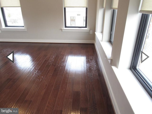 empty room with dark hardwood / wood-style floors