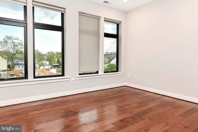 2 Stationmaster St SE Unit 302, Leesburg, VA 20175 - empty room featuring a healthy amount of sunlight, baseboards, and wood finished floors