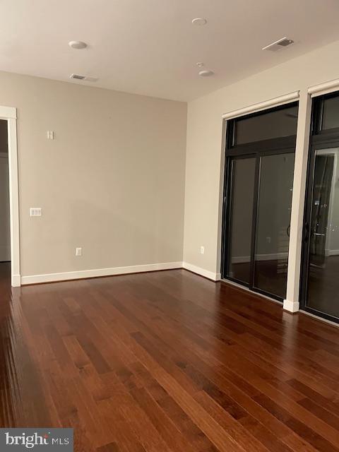 spare room with dark hardwood / wood-style floors