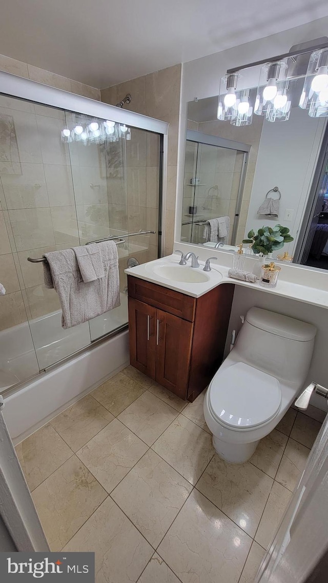 full bathroom with toilet, bath / shower combo with glass door, tile patterned floors, and vanity