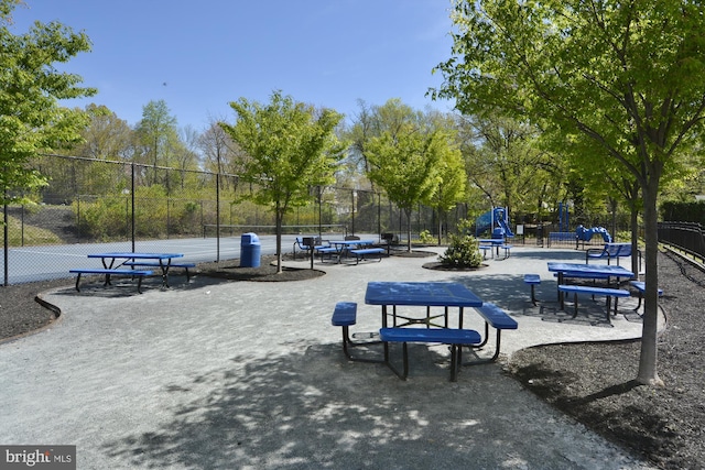 view of home's community featuring tennis court