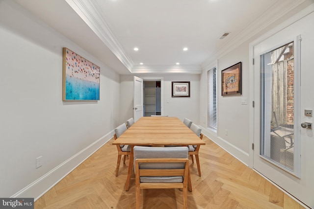 dining room with crown molding and light parquet flooring