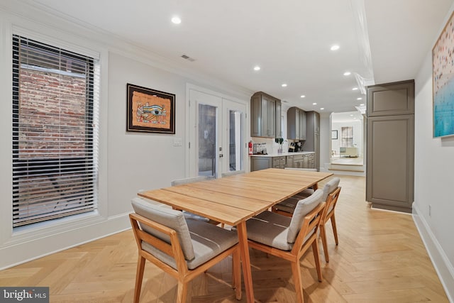 dining room featuring light parquet flooring and ornamental molding