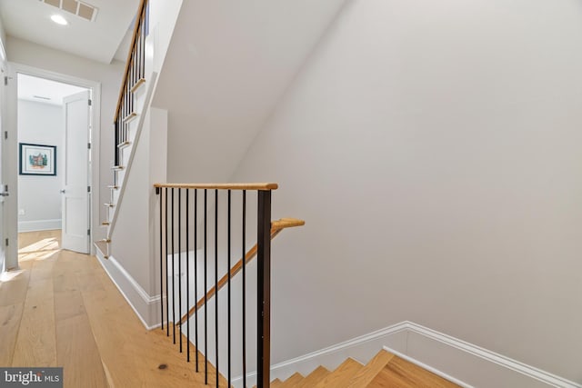 stairway featuring wood-type flooring