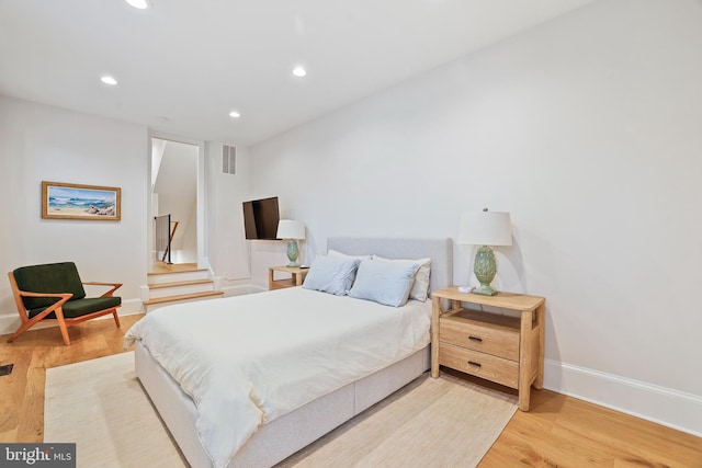 bedroom with hardwood / wood-style flooring