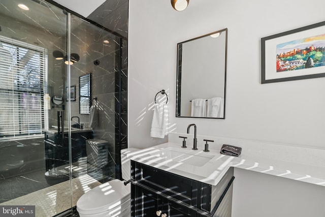 bathroom with vanity, toilet, and walk in shower