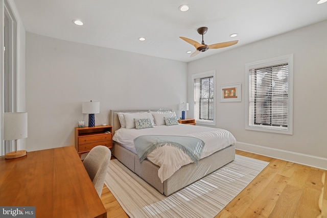 bedroom with ceiling fan and light wood-type flooring