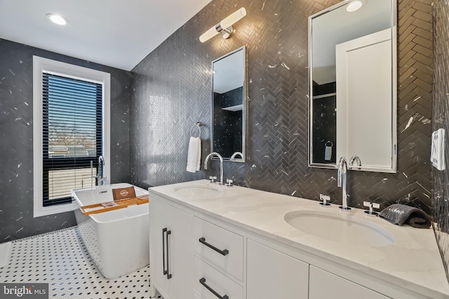 bathroom with vanity, a bath, and tile patterned flooring