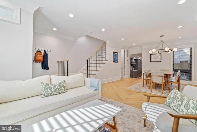 living room featuring crown molding, light parquet flooring, and a chandelier