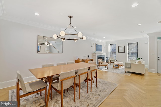 dining room with light parquet floors, crown molding, and a chandelier