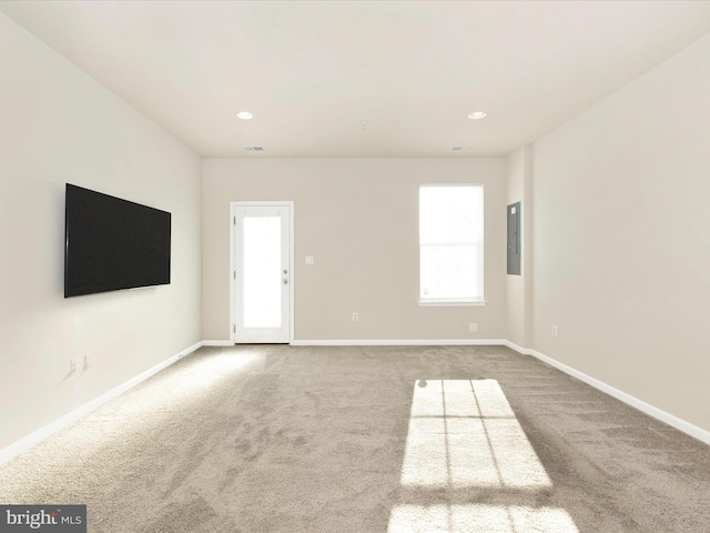 empty room with carpet and electric panel