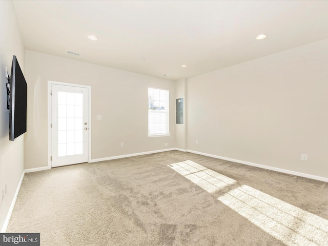 unfurnished room with electric panel and carpet flooring