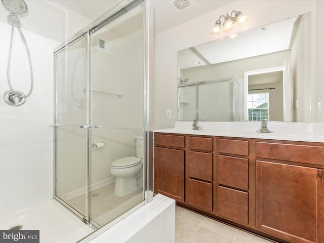 bathroom featuring vanity, toilet, an enclosed shower, and tile patterned flooring