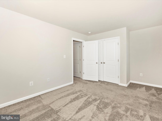 unfurnished bedroom featuring a closet and carpet