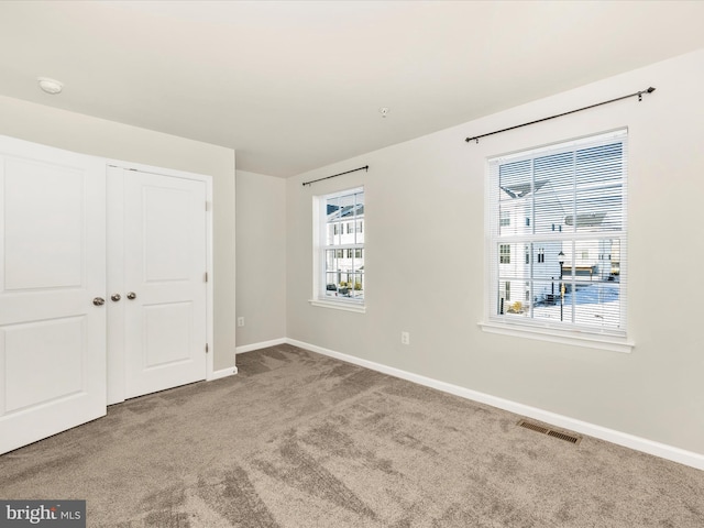 unfurnished bedroom featuring a closet and carpet flooring