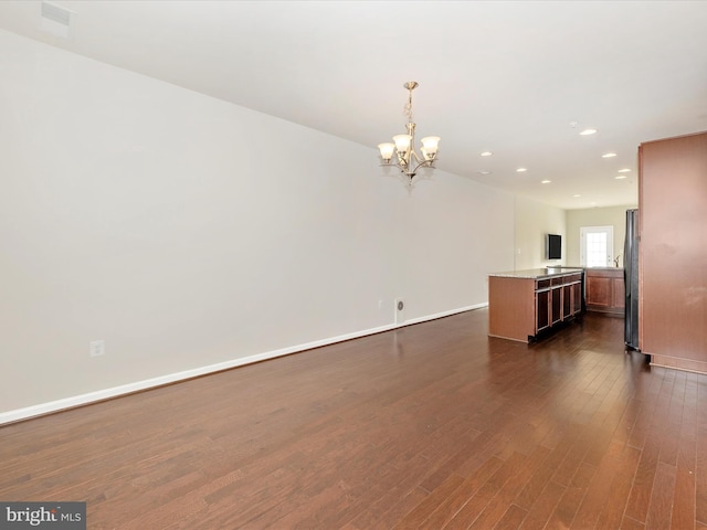 interior space featuring a chandelier and dark hardwood / wood-style floors