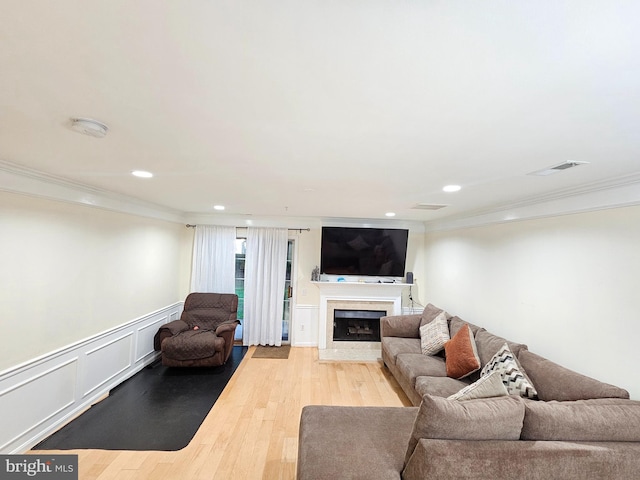 living room featuring light hardwood / wood-style floors and ornamental molding