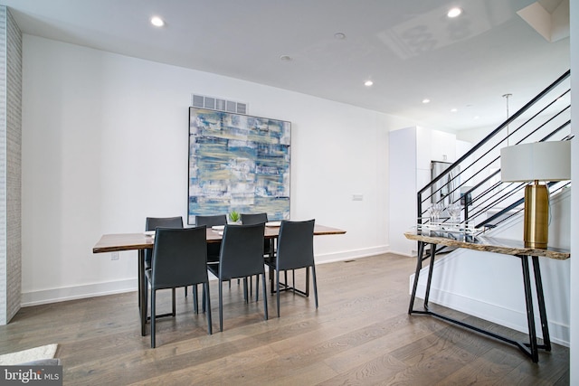 dining space with hardwood / wood-style floors