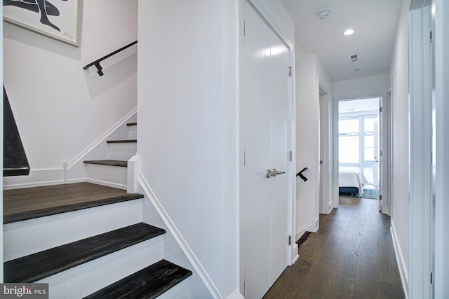 staircase featuring wood-type flooring