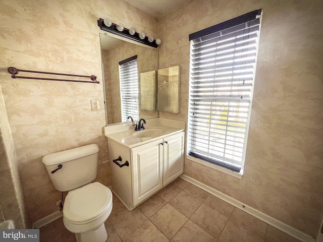 bathroom featuring vanity, tile patterned flooring, and toilet