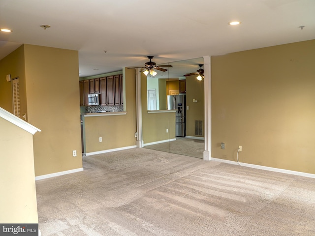 unfurnished living room featuring light colored carpet