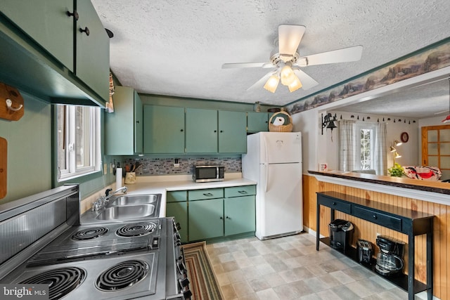 kitchen featuring stainless steel appliances, a healthy amount of sunlight, sink, and green cabinets