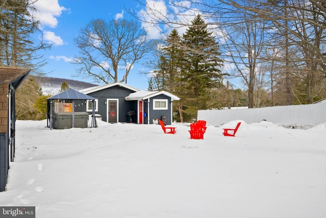 snowy yard featuring a hot tub