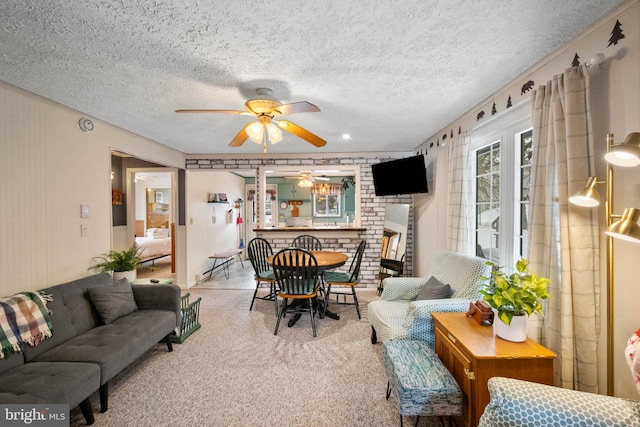 living room with ceiling fan and a textured ceiling